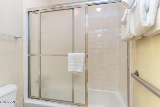 a bathroom with a shower and a toilet