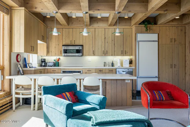 a kitchen with a sink refrigerator and cabinets