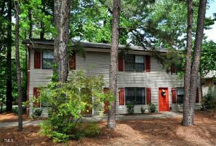 228 Adams Street Cary, NC 27513 - Photo 5 of 6 a front view of a house with plants and trees