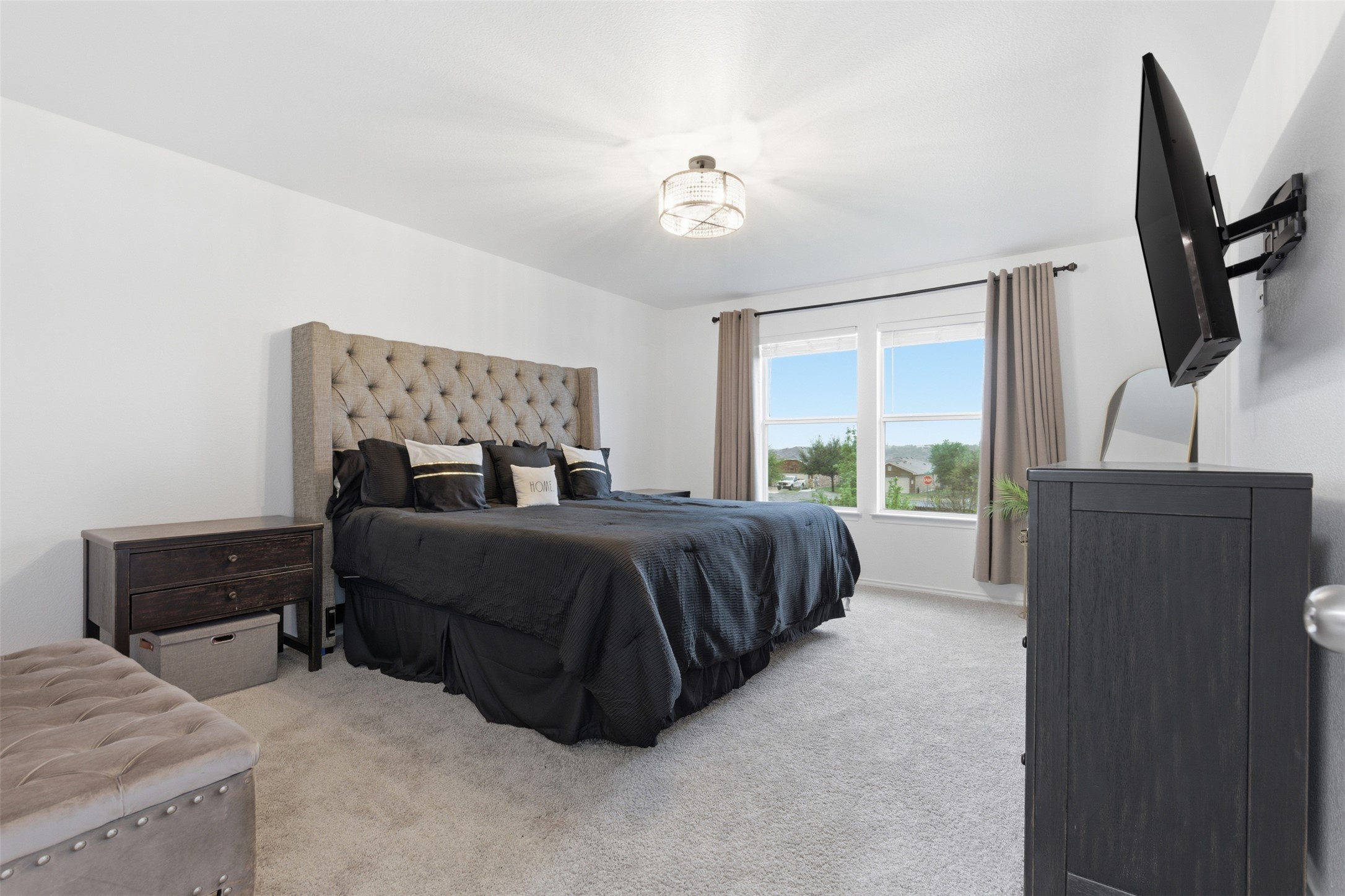 101 Magpie Goose Lane Leander, TX 78641 - Photo 13 of 29 a bedroom with a large bed and a dresser