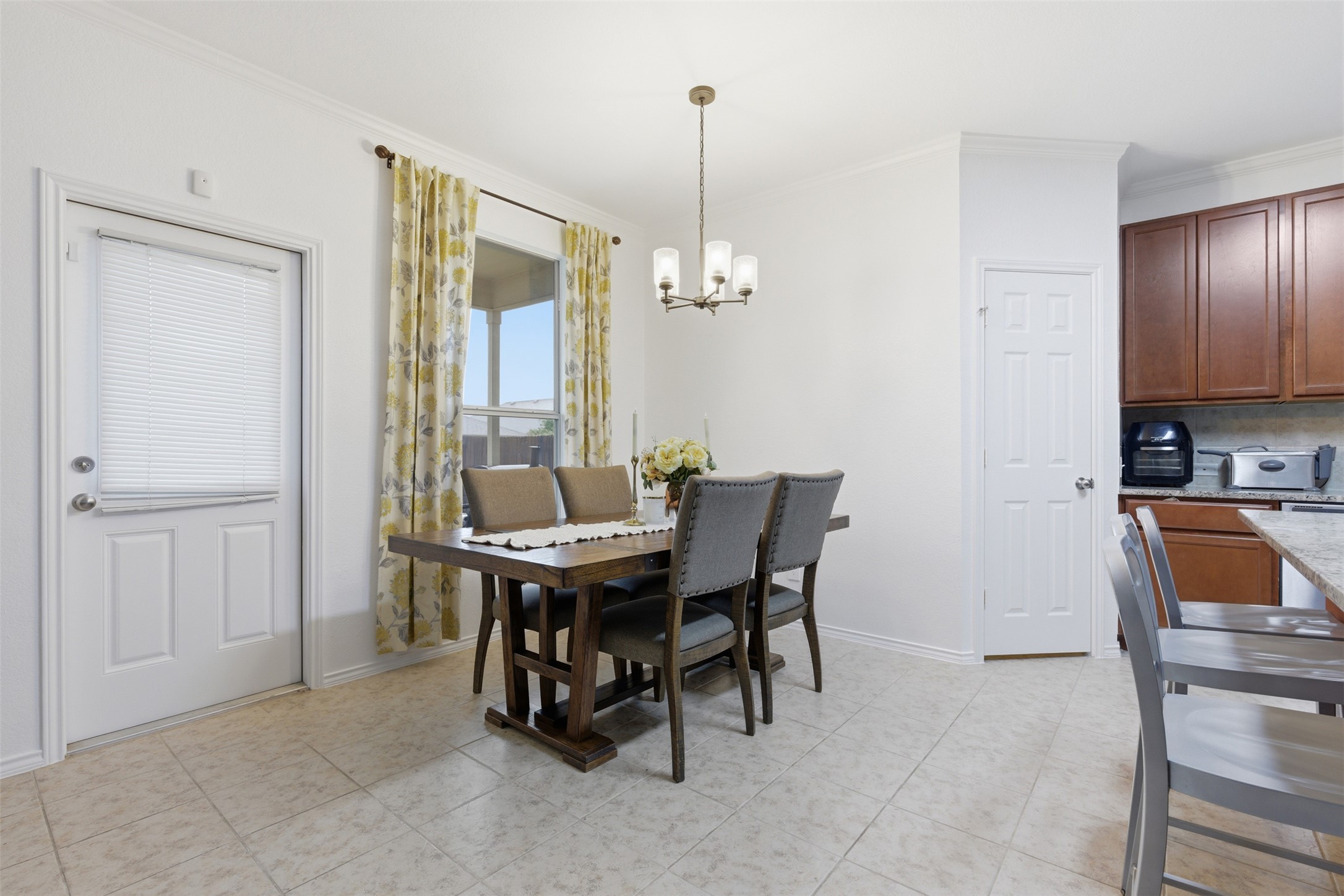 101 Magpie Goose Lane Leander, TX 78641 - Photo 10 of 29 a view of a dining room with furniture and chandelier
