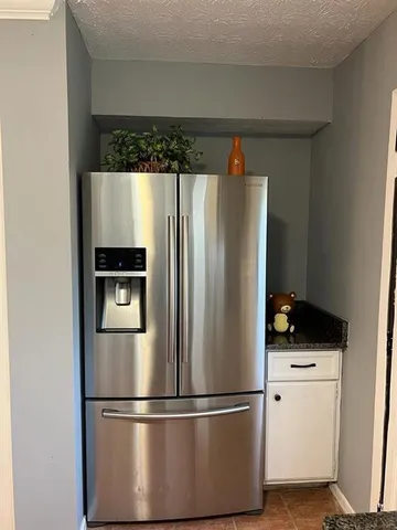a close view of a refrigerator a stove and a refrigerator