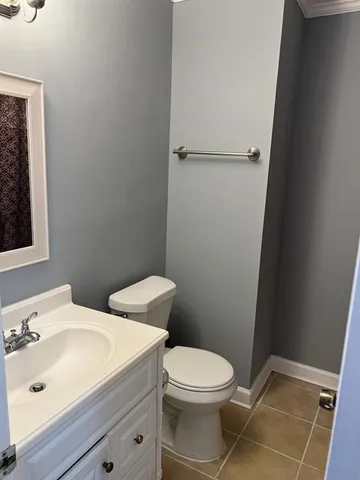 a bathroom with a sink a toilet and vanity