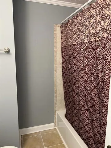 a bathroom with a shower curtain