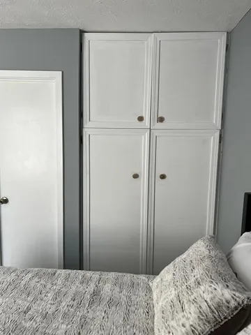 a bedroom with a bed and a bathroom