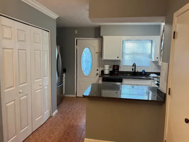 a view of a kitchen with a refrigerator and a stove