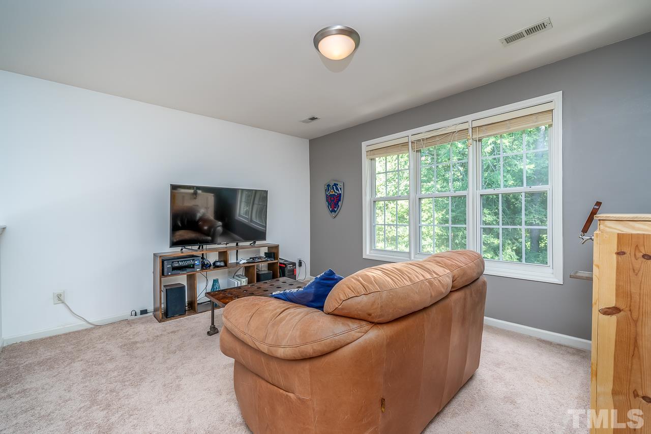 713 Windcrest Road Durham, NC 27713 - Photo 20 of 27 Enjoy some extra space to hang out or watch television in the room loft overlooking the private backyard.
