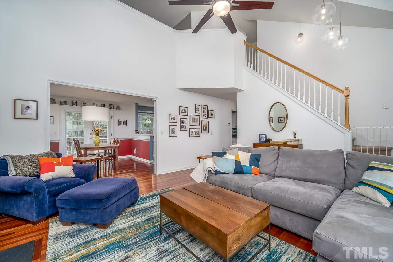 713 Windcrest Road Durham, NC 27713 - Photo 5 of 27 View of the grand staircase, loft above, and kitchen/dining area to the left.