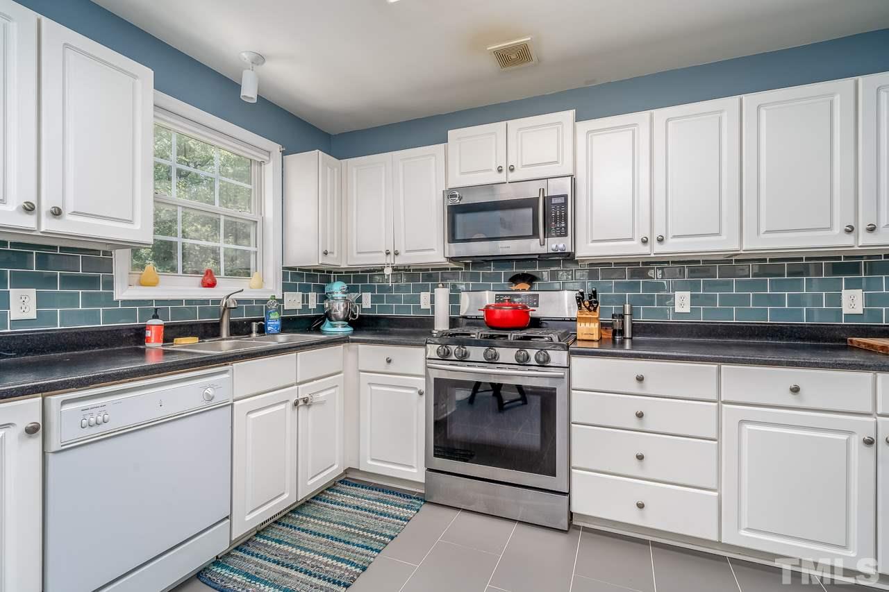 713 Windcrest Road Durham, NC 27713 - Photo 7 of 27 Beautiful upgraded kitchen has a gas stove, new subway tile, and new tile floors.