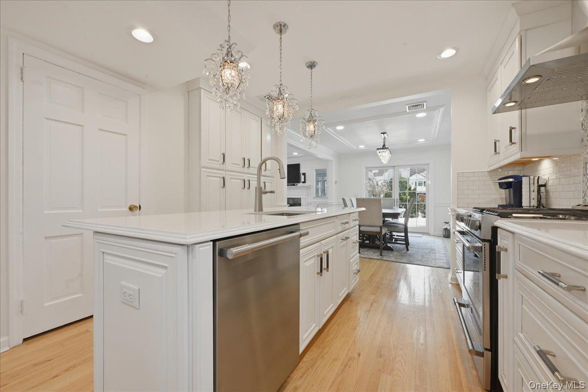 210 Clinton Road Garden City, NY 11530 - Photo 11 of 31 a large white kitchen with lots of counter space a sink and appliances