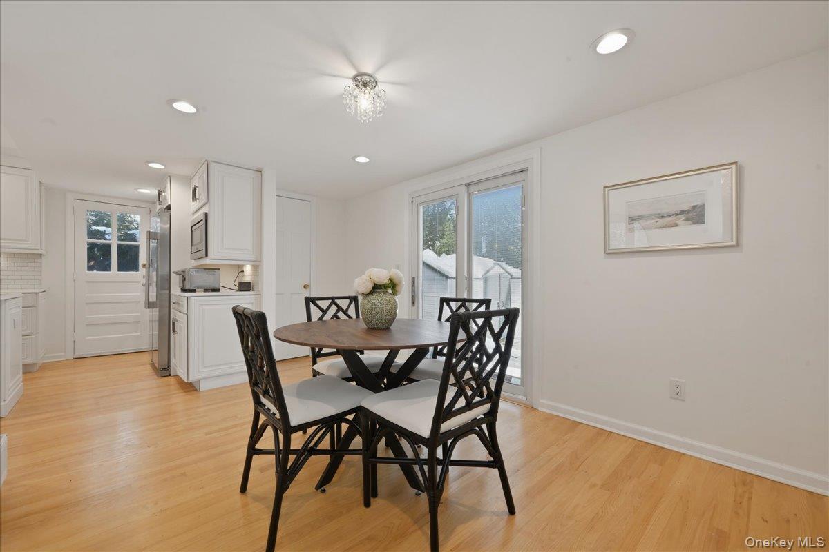 210 Clinton Road Garden City, NY 11530 - Photo 14 of 31 a view of a dining room with furniture and a chandelier