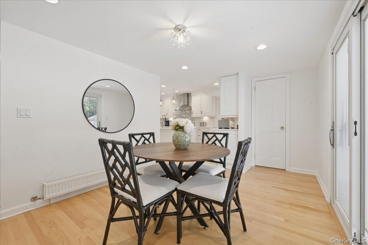210 Clinton Road Garden City, NY 11530 - Photo 15 of 31 a view of a dining room with furniture and chandelier
