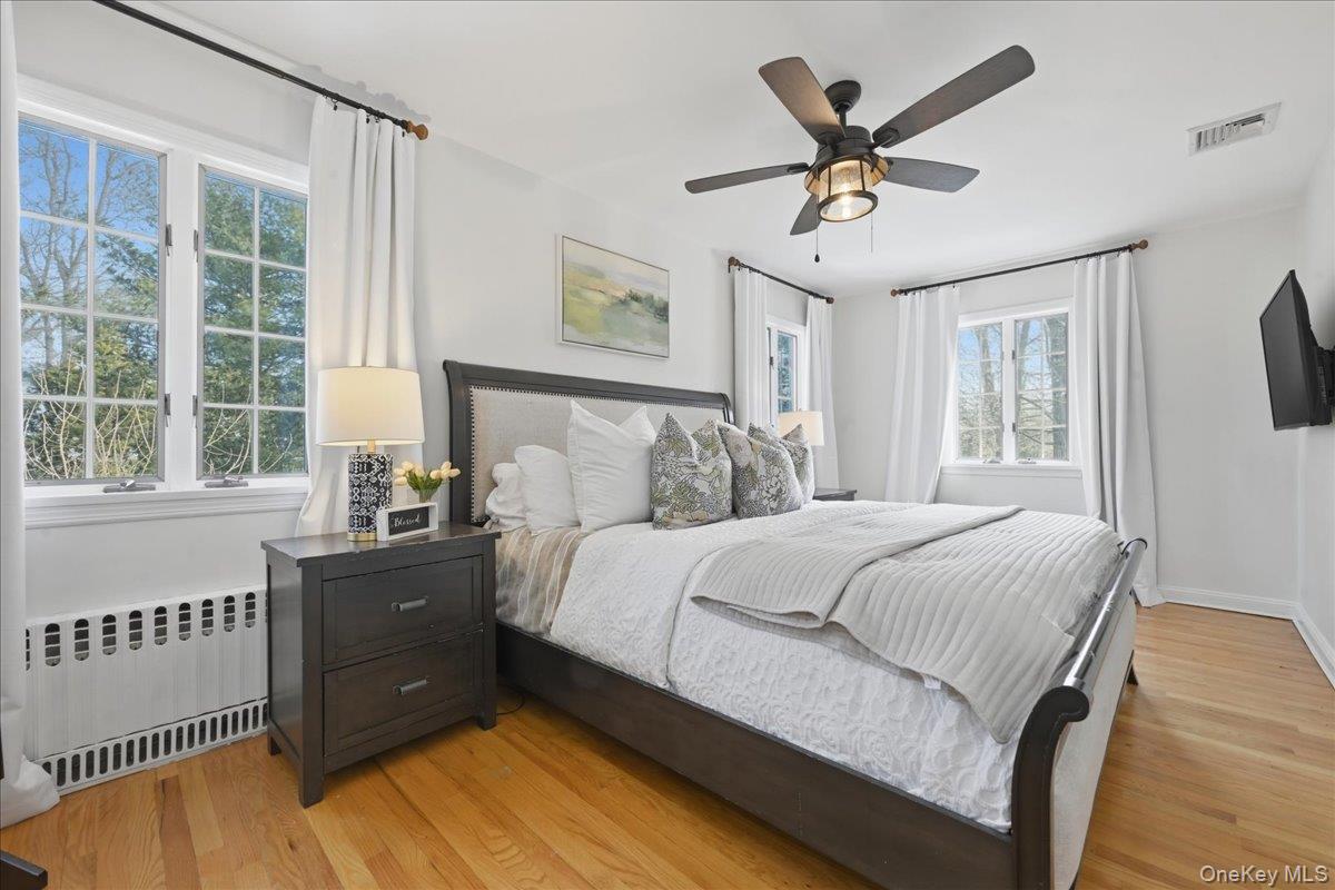 210 Clinton Road Garden City, NY 11530 - Photo 17 of 31 a bedroom with a bed and window