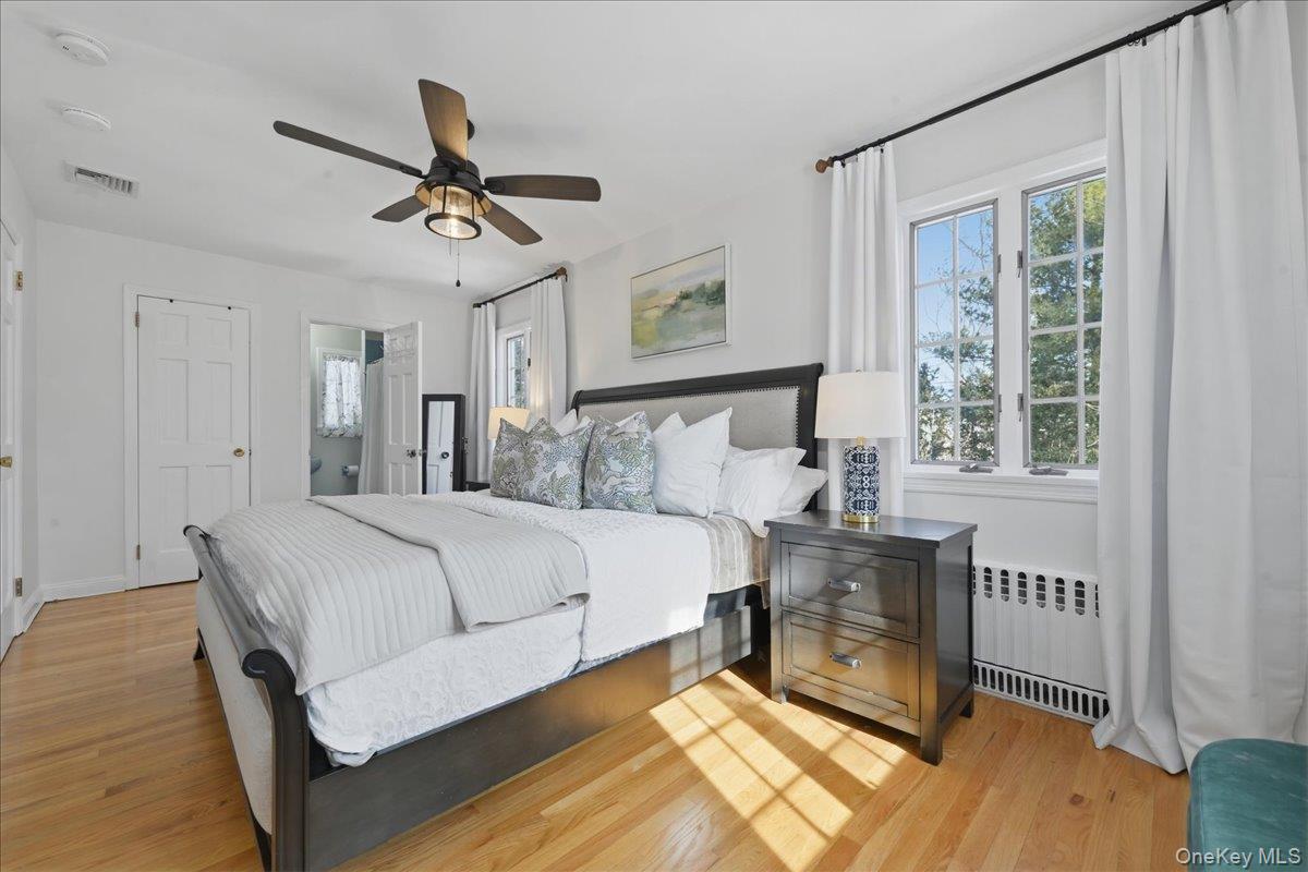 210 Clinton Road Garden City, NY 11530 - Photo 18 of 31 a bed room with a bed and a window