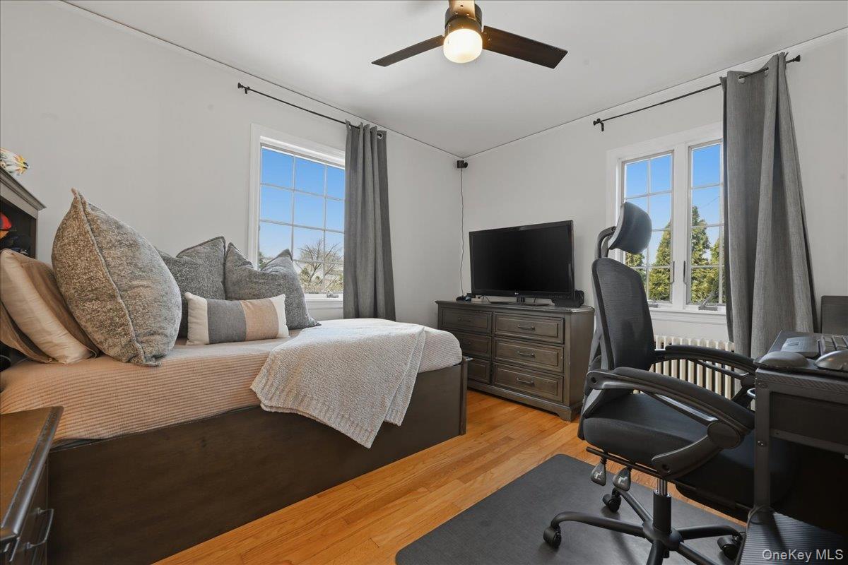 210 Clinton Road Garden City, NY 11530 - Photo 20 of 31 a bedroom with furniture and a flat screen tv