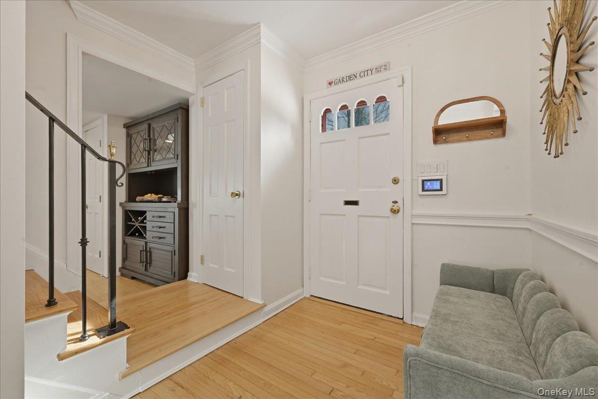 210 Clinton Road Garden City, NY 11530 - Photo 2 of 31 a living room with a couch and a stove top oven