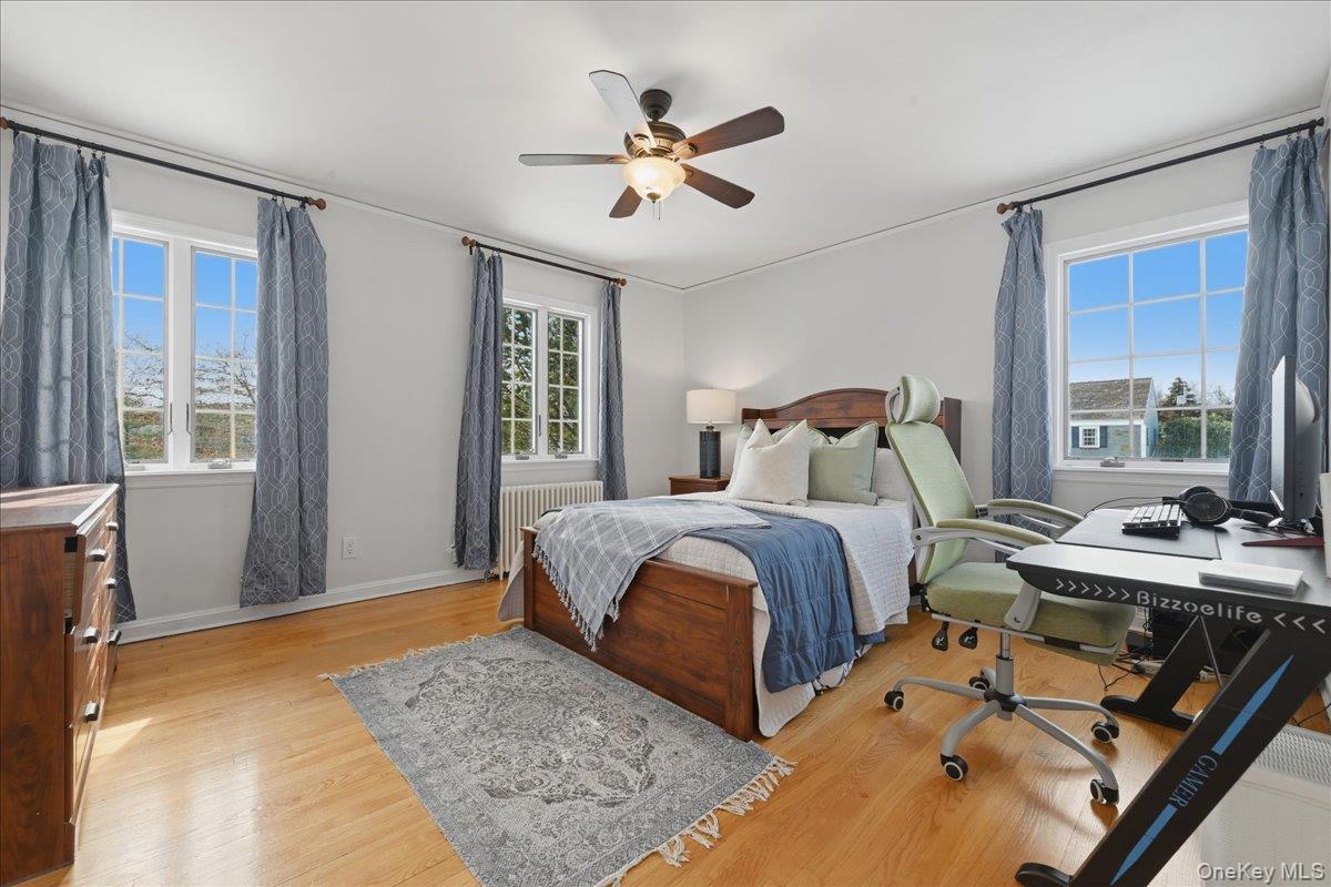 210 Clinton Road Garden City, NY 11530 - Photo 21 of 31 a bedroom with a bed and window