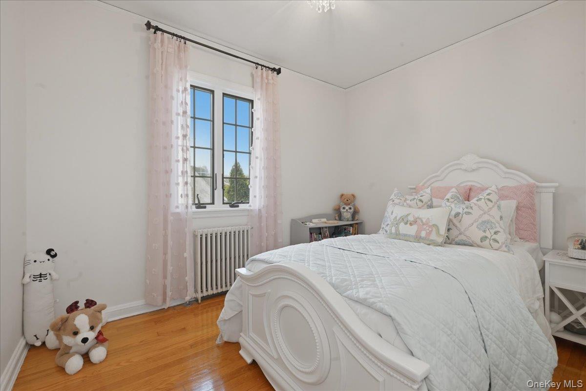 210 Clinton Road Garden City, NY 11530 - Photo 23 of 31 a bedroom with a bed and a window
