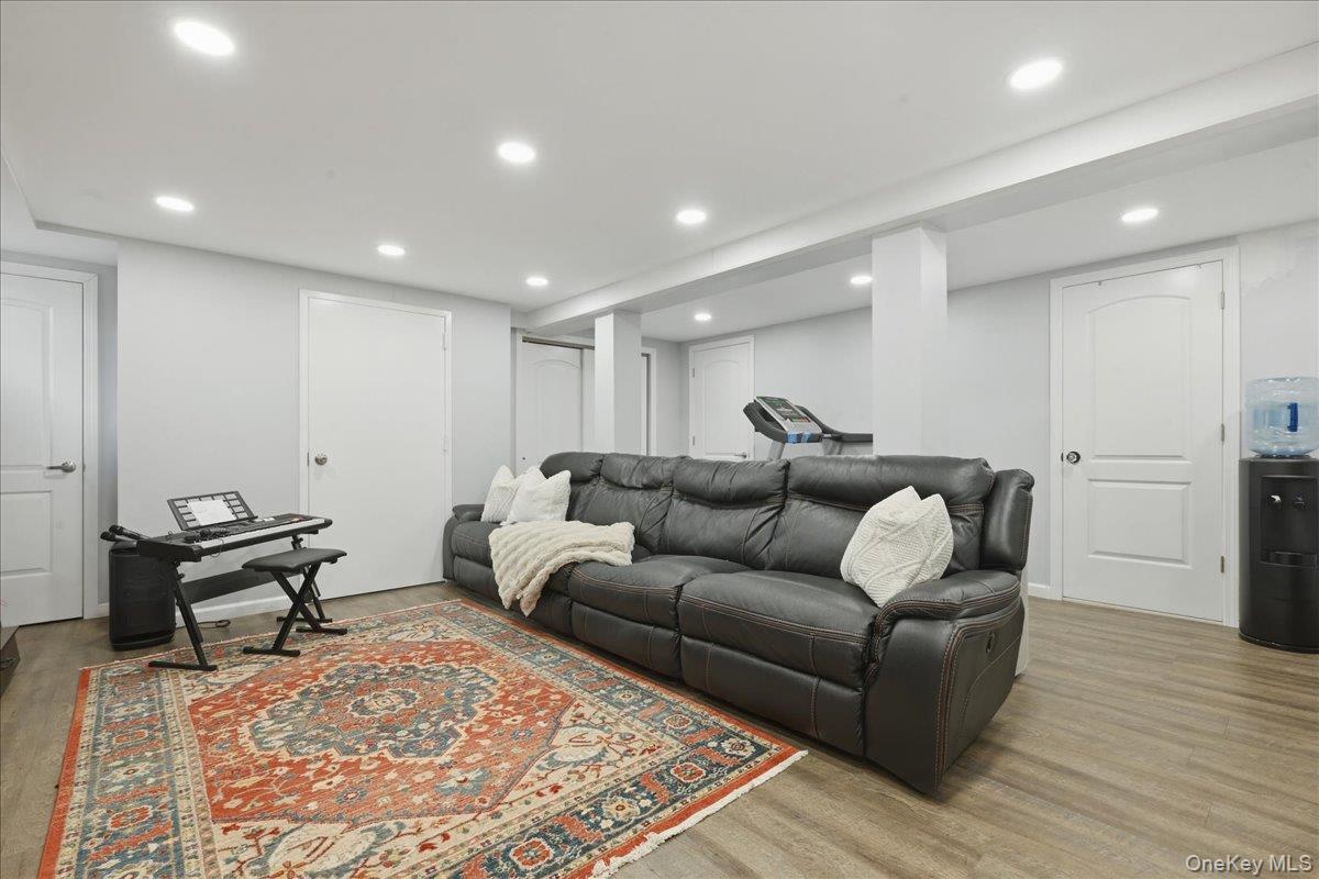 210 Clinton Road Garden City, NY 11530 - Photo 25 of 31 a living room with furniture and a wooden floor