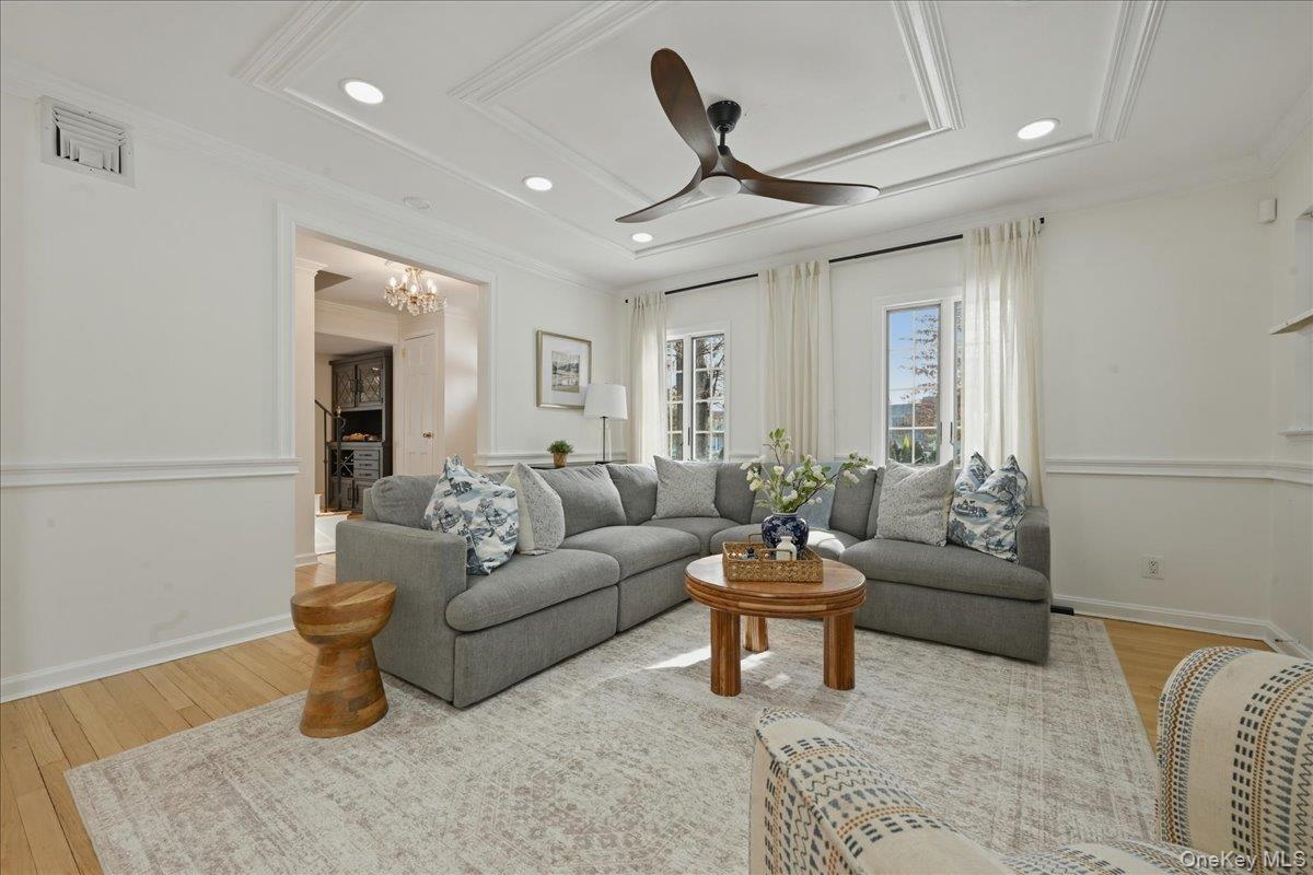 210 Clinton Road Garden City, NY 11530 - Photo 4 of 31 a living room with furniture and a chandelier