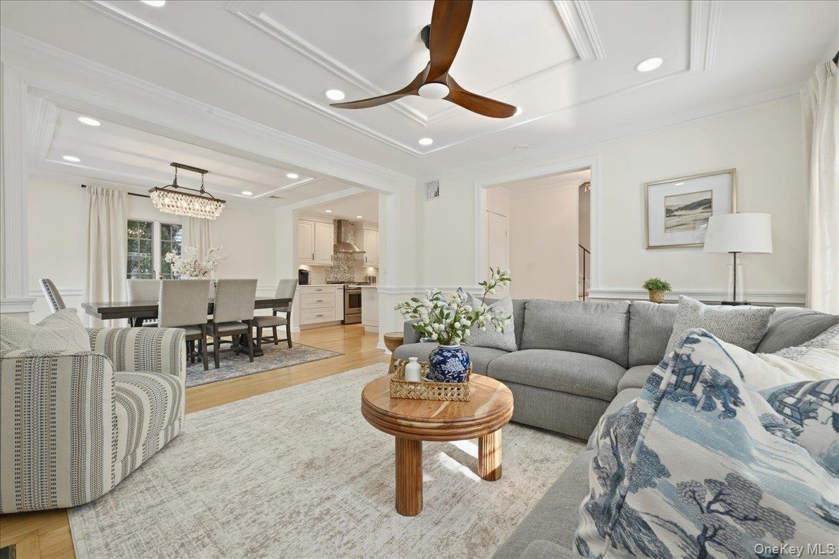 210 Clinton Road Garden City, NY 11530 - Photo 5 of 31 a living room with furniture and a chandelier