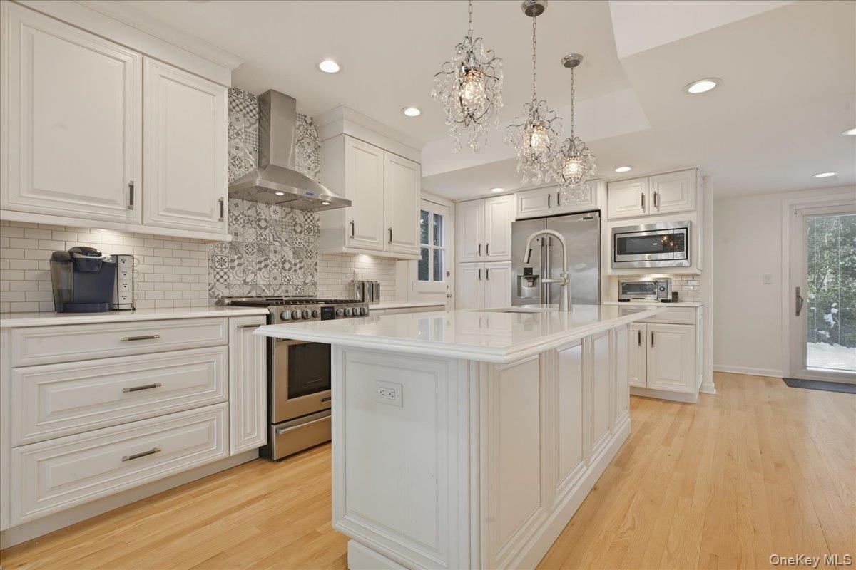 210 Clinton Road Garden City, NY 11530 - Photo 8 of 31 a kitchen with kitchen island granite countertop a white stove top oven and cabinets