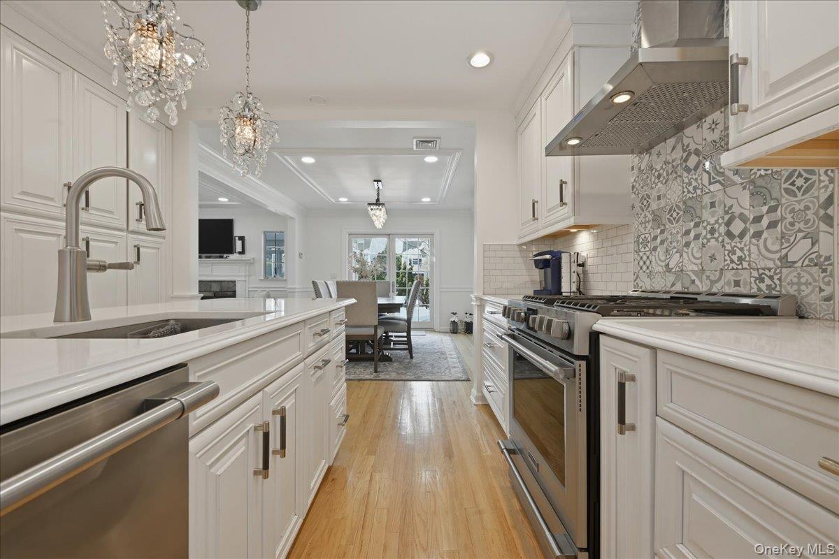 210 Clinton Road Garden City, NY 11530 - Photo 9 of 31 a large kitchen with a sink and stainless steel appliances