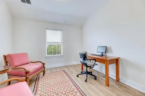 a work room with furniture and wooden floor
