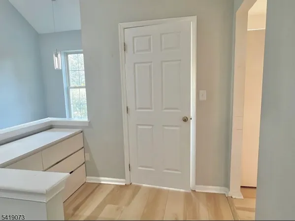 a view of an entryway with wooden floor