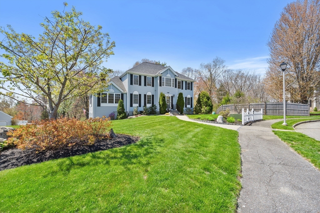 16 Alan Road Hudson, MA 01749 - Photo 3 of 42 a front view of a house with garden and trees