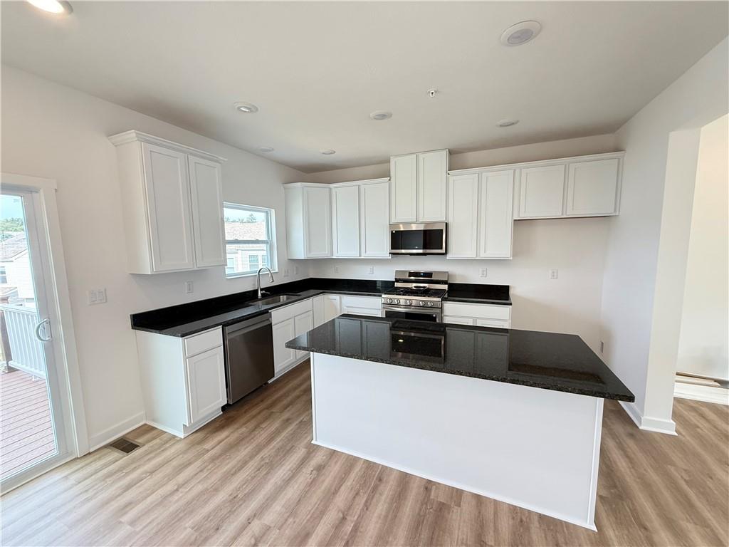 175 Lockheed Drive Coraopolis, PA 15108 - Photo 10 of 17 a kitchen with granite countertop a sink a stove top oven and cabinetry