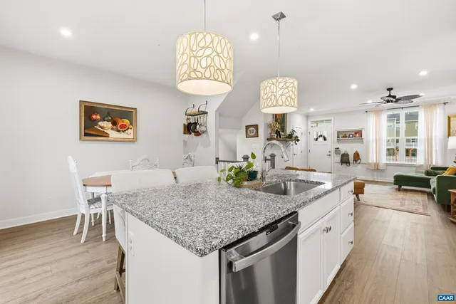 a view of a kitchen island furniture wooden floor and a chandelier
