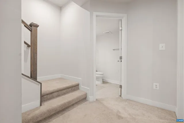 a spacious bathroom with a toilet and a shower