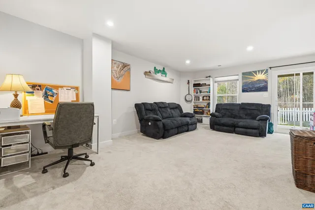a living room with furniture a couch and a window