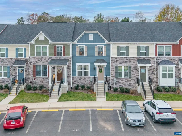 a front view of a residential apartment building with a yard