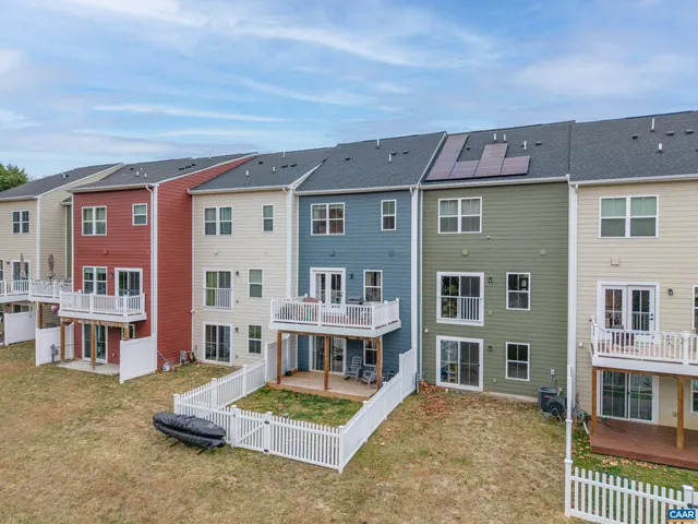 a view of a house with pool and chairs
