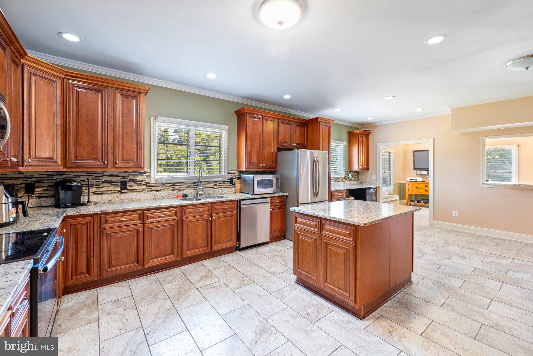 61 Magothy Beach Road Pasadena, MD 21122 - Photo 15 of 63 a kitchen with stainless steel appliances granite countertop a stove top oven a sink dishwasher and a refrigerator