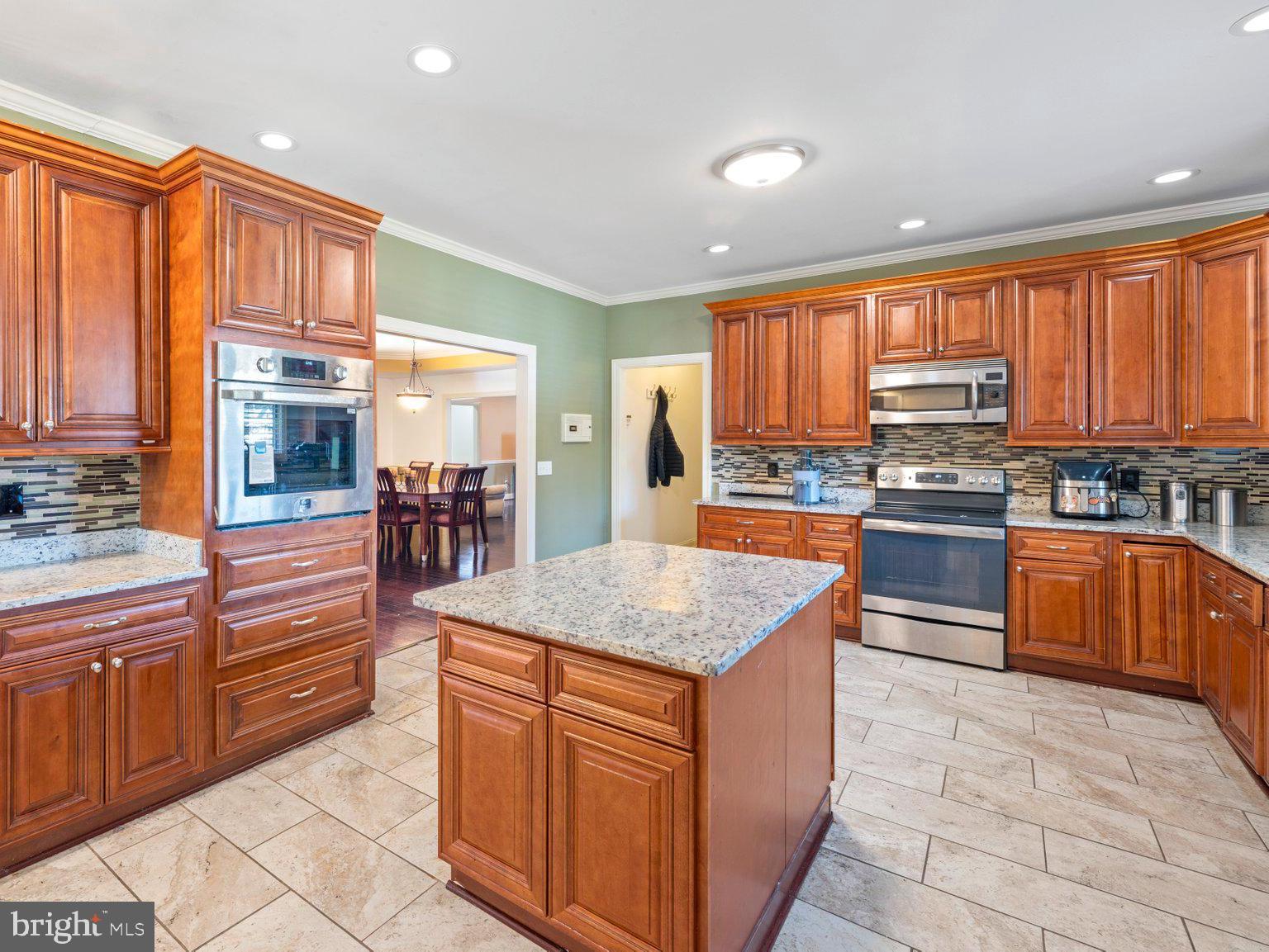 61 Magothy Beach Road Pasadena, MD 21122 - Photo 17 of 63 a kitchen with stainless steel appliances granite countertop a stove a sink dishwasher and a refrigerator