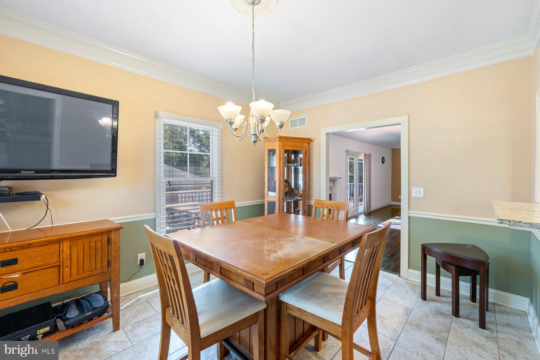 61 Magothy Beach Road Pasadena, MD 21122 - Photo 21 of 63 a view of a dining room with furniture and chandelier