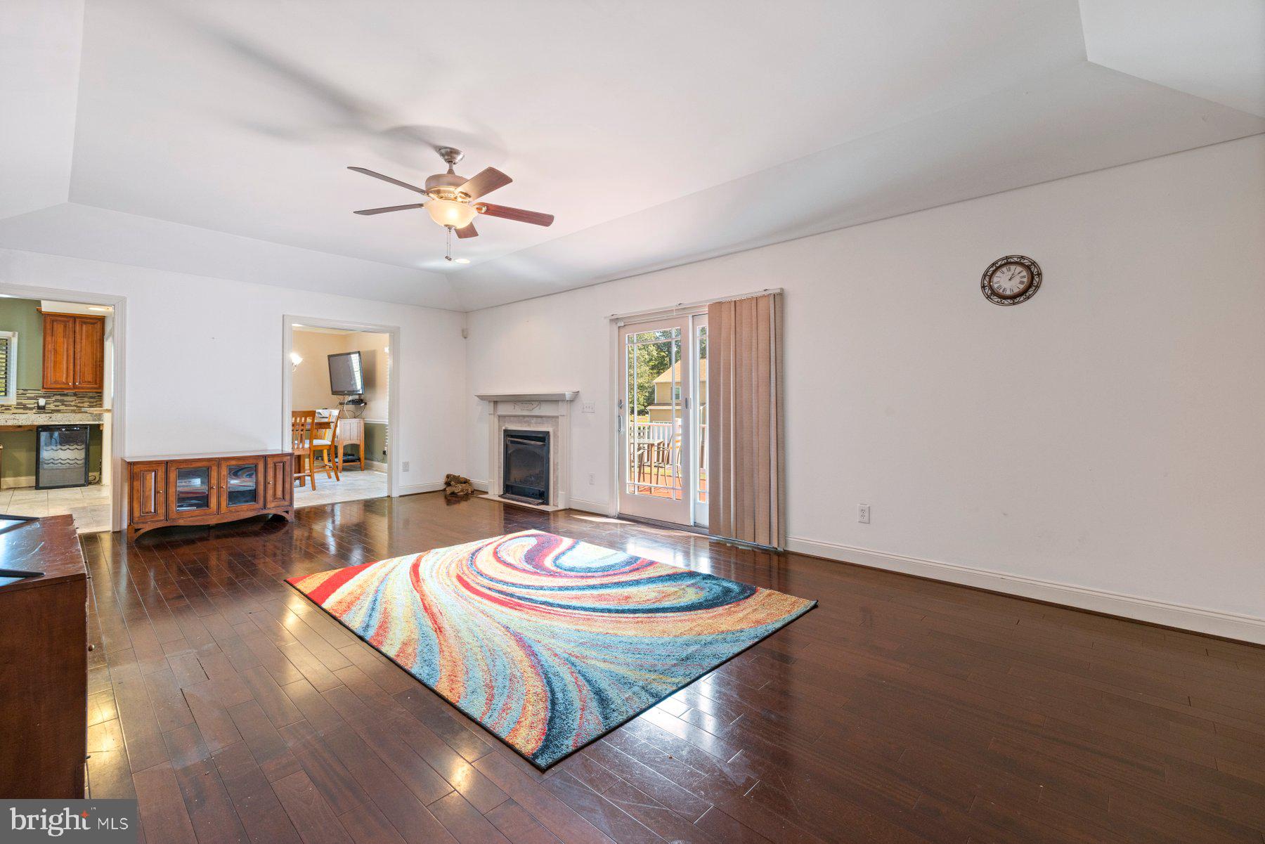 61 Magothy Beach Road Pasadena, MD 21122 - Photo 25 of 63 a living room with fireplace furniture and a wooden floor