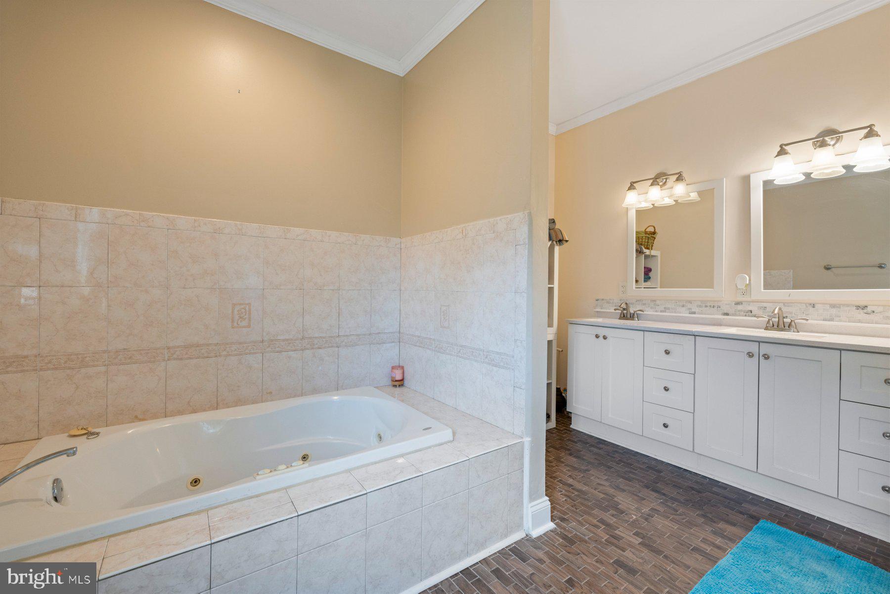 61 Magothy Beach Road Pasadena, MD 21122 - Photo 28 of 63 a bathroom with a tub sink and mirror