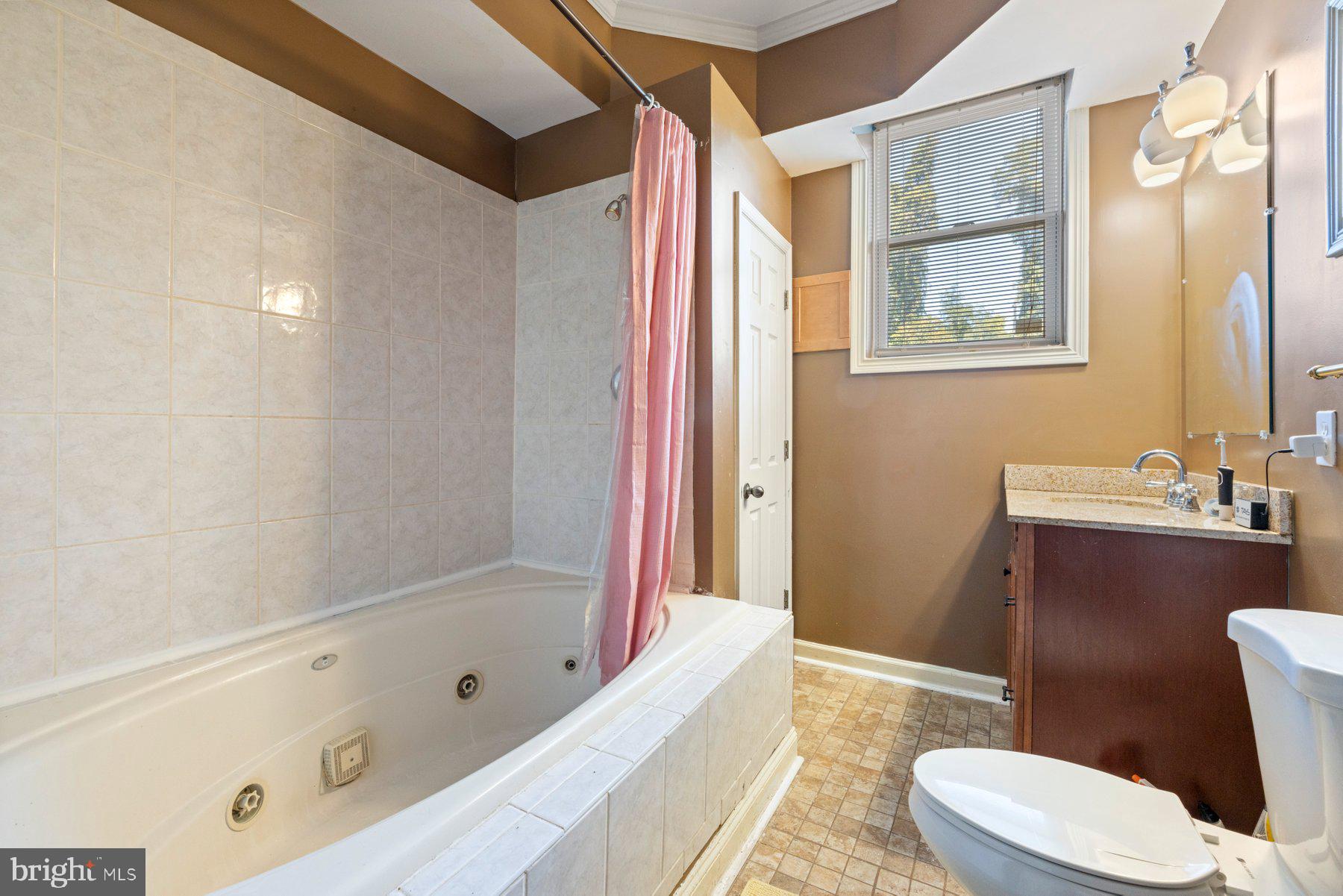 61 Magothy Beach Road Pasadena, MD 21122 - Photo 47 of 63 a bathroom with a bathtub sink and toilet
