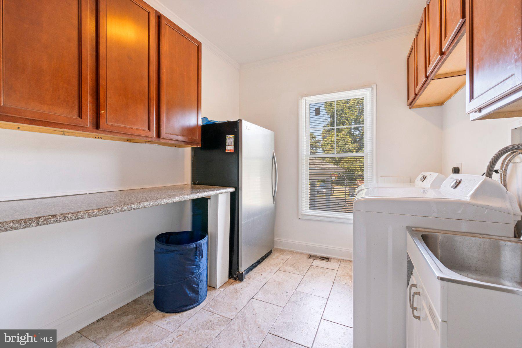 61 Magothy Beach Road Pasadena, MD 21122 - Photo 54 of 63 a kitchen with a sink and a refrigerator