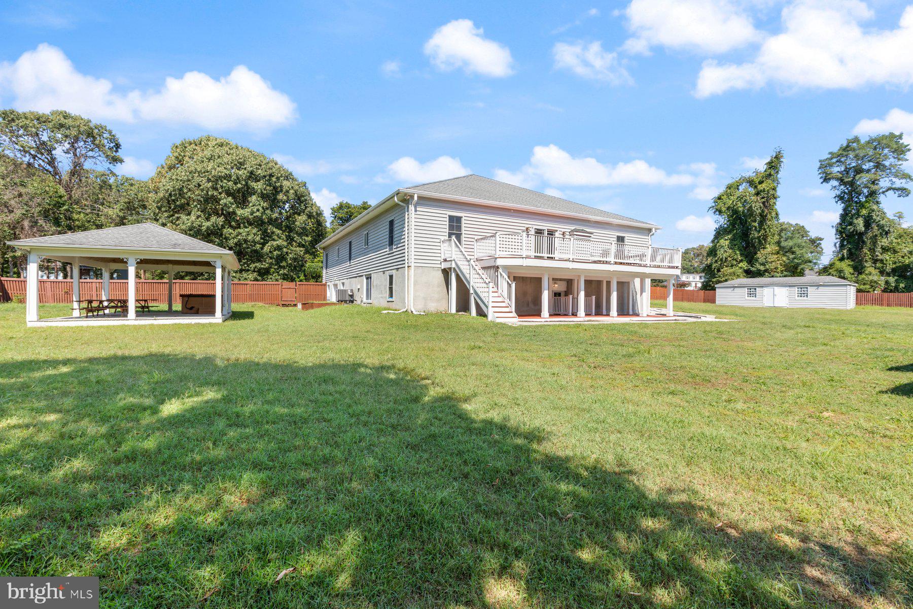61 Magothy Beach Road Pasadena, MD 21122 - Photo 57 of 63 a view of a house next to a big yard and large trees
