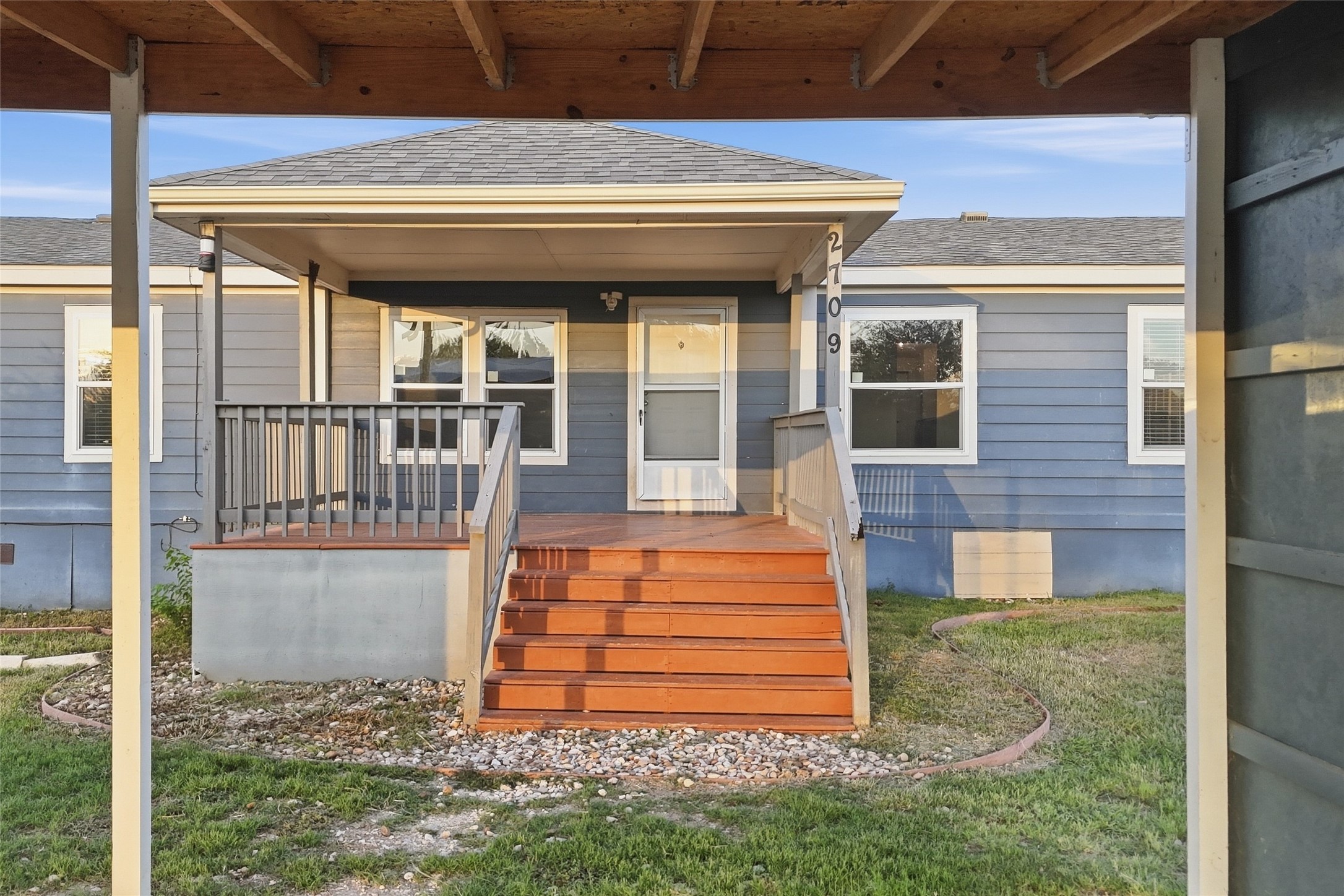 2709 County Road 463 Elgin, TX 78621 - Photo 4 of 32 Wooden steps lead to a welcoming front porch under a classic gabled roofline.