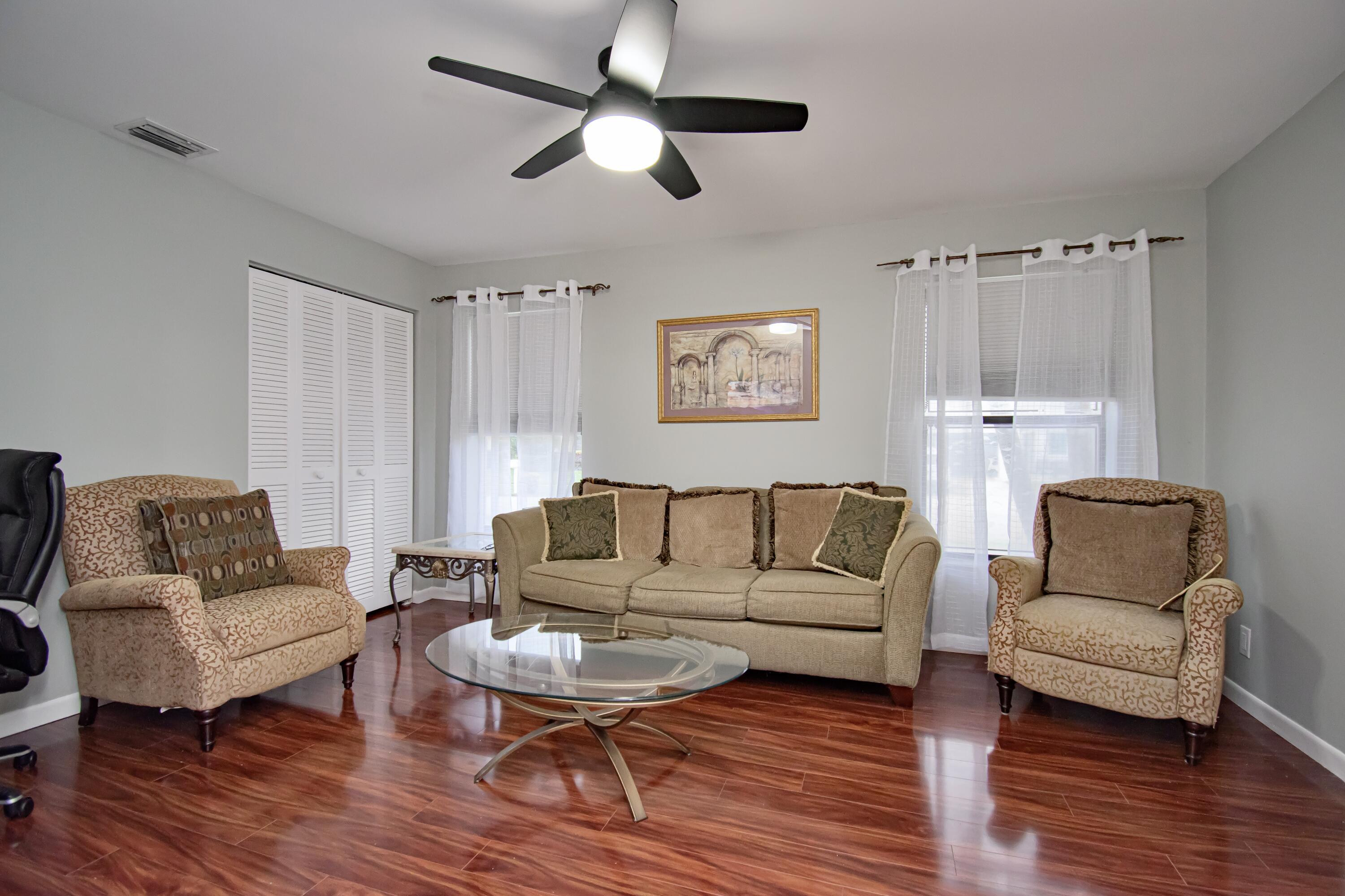 7838 Cypress Crescent Boca Raton, FL 33433 - Photo 16 of 24 a living room with furniture and a wooden floor