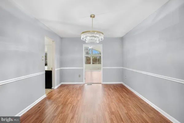 a view of a room with wooden floor cabinets and a window