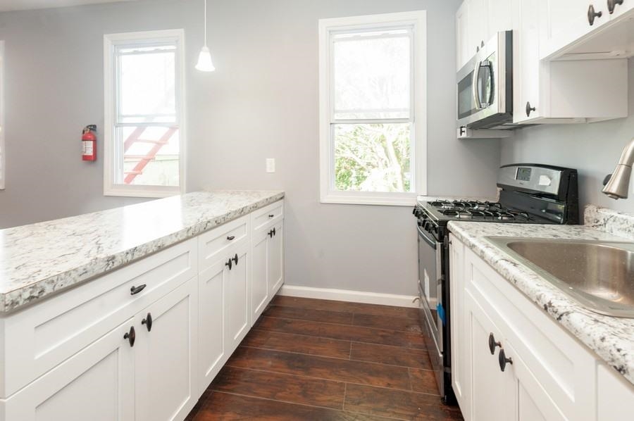 705 8th Street, Unit 2 Union City, NJ 07087 - Photo 1 of 19 a kitchen with granite countertop a sink and a stove
