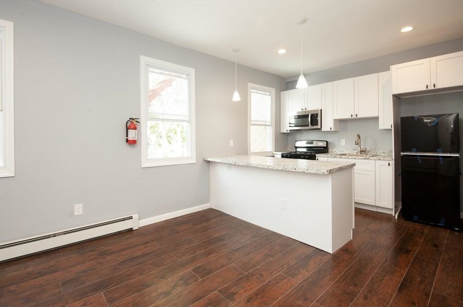 705 8th Street, Unit 2 Union City, NJ 07087 - Photo 3 of 19 a kitchen with a refrigerator and a stove top oven