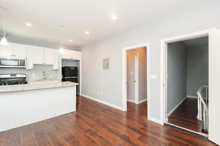 705 8th Street, Unit 2 Union City, NJ 07087 - Photo 6 of 19 a kitchen with stainless steel appliances granite countertop a refrigerator and a stove top oven